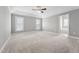 Spacious main bedroom with tray ceiling, ceiling fan, and ensuite bathroom access at 105 Bagley Ln, Dunn, NC 28334