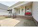 Inviting covered patio with brick foundation, comfortable seating, and an exterior fan at 105 Bagley Ln, Dunn, NC 28334