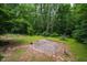Backyard patio area surrounded by lush greenery and trees at 106 Redbud, Pittsboro, NC 27312