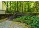 Backyard entrance with steps and surrounding greenery at 106 Redbud, Pittsboro, NC 27312