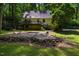 The backyard shows a patio, wooden deck, and mature trees at 106 Redbud, Pittsboro, NC 27312