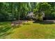 The backyard has a stone patio, lawn, and mature tree coverage at 106 Redbud, Pittsboro, NC 27312