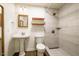 Modern bathroom featuring tiled shower, pedestal sink, and stylish fixtures with wood accents at 106 Redbud, Pittsboro, NC 27312