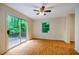 Bright bedroom features hardwood floors, large window and sliding glass doors to a private deck at 106 Redbud, Pittsboro, NC 27312