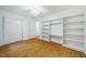 Bedroom with hardwood floors, built-in shelving, ceiling fan, and closet space at 106 Redbud, Pittsboro, NC 27312