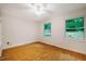 Cozy bedroom with hardwood floors, two windows, and a ceiling fan at 106 Redbud, Pittsboro, NC 27312