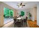 Inviting dining room with sliding glass doors to deck, modern ceiling fan, and natural light at 106 Redbud, Pittsboro, NC 27312