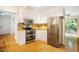 Clean kitchen with white cabinets, butcher block counters, stainless steel appliances and hardwood flooring at 106 Redbud, Pittsboro, NC 27312