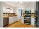 Modern kitchen with stainless steel appliances, white cabinets, hardwood floors and butcher block countertops at 106 Redbud, Pittsboro, NC 27312