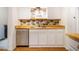 Bright kitchen features white cabinets, stainless steel appliances, butcher block countertops, and decorative backsplash at 106 Redbud, Pittsboro, NC 27312