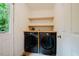 Convenient laundry room with modern washer and dryer, butcher block countertop and ample shelving at 106 Redbud, Pittsboro, NC 27312
