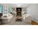 Cozy living room showcasing a stone fireplace, built-in shelves, and comfortable furniture, great for relaxing at 106 Redbud, Pittsboro, NC 27312