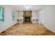 Bright living room with hardwood floors, stone fireplace, and built-in shelving, creating a warm atmosphere at 106 Redbud, Pittsboro, NC 27312