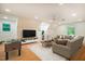 Spacious living room featuring a comfortable sofa, and a game table at 106 Redbud, Pittsboro, NC 27312