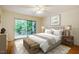 Comfortable primary bedroom featuring hardwood floors, a sliding door to a deck, and natural light at 106 Redbud, Pittsboro, NC 27312