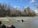 Beautiful view of a river with rushing water and trees lining the banks, promoting outdoor living at 106 Redbud, Pittsboro, NC 27312