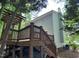 Light blue two-story house with a large wooden back deck and stairs leading down to the yard at 109 Elmview Dr, Cary, NC 27519