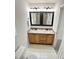 Bright bathroom featuring a double sink vanity with wood cabinets and large framed mirrors at 109 Elmview Dr, Cary, NC 27519