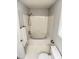 Clean bathroom featuring a tub with white tiling and a toilet with window at 109 Elmview Dr, Cary, NC 27519