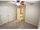 Carpeted bedroom featuring a ceiling fan, closet and neutral walls at 109 Elmview Dr, Cary, NC 27519