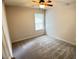Neutral bedroom featuring carpet, a ceiling fan, and a window offering natural light at 109 Elmview Dr, Cary, NC 27519