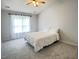 Well-lit bedroom with a white bed, carpeted floors, and a window dressed with sheer curtains at 109 Elmview Dr, Cary, NC 27519