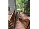 Wooden deck with steps down to the backyard and access to the side of the home at 109 Elmview Dr, Cary, NC 27519