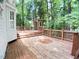 Wooden deck with multiple levels surrounded by tall trees, creating a serene outdoor space at 109 Elmview Dr, Cary, NC 27519