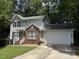 Charming two-story home with brick accents, complemented by a well-maintained lawn and a convenient two-car garage at 109 Elmview Dr, Cary, NC 27519