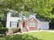 Attractive two-story home with a red brick accent, vinyl siding, a well-manicured lawn, and a two-car garage for convenient parking at 109 Elmview Dr, Cary, NC 27519