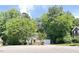Charming single-story home with a red front door, attached garage, and mature trees at 109 Elmview Dr, Cary, NC 27519