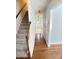 Inviting hallway featuring hardwood floors, a staircase, and a view into a bright, open area with ample natural light at 109 Elmview Dr, Cary, NC 27519