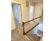 Upper hallway featuring carpeting, white railings, and multiple doors leading to various rooms at 109 Elmview Dr, Cary, NC 27519
