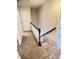 Carpeted hallway features a stairwell leading upstairs and multiple doors at 109 Elmview Dr, Cary, NC 27519