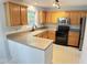 Well-lit kitchen with wood cabinetry and stainless steel appliances at 109 Elmview Dr, Cary, NC 27519