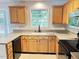 Kitchen with neutral counters, window view, and wooden cabinetry at 109 Elmview Dr, Cary, NC 27519