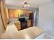Modern kitchen with stainless steel refrigerator and wood cabinets at 109 Elmview Dr, Cary, NC 27519