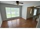 Bright living room with hardwood floors, a ceiling fan, and a large window, offering a comfortable and airy space at 109 Elmview Dr, Cary, NC 27519