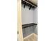 Organized walk-in closet featuring carpeted floors and dark wood shelving for ample storage at 109 Elmview Dr, Cary, NC 27519