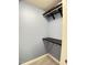 Walk-in closet with carpeting and dark wood organizers offering ample storage space at 109 Elmview Dr, Cary, NC 27519