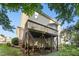 Backyard view showcases the rear of the house and a raised deck at 109 Faldo Cv, Raleigh, NC 27603