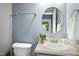 Bathroom featuring a modern sink, toilet, and towel rack, illuminated by soft, natural light at 109 Faldo Cv, Raleigh, NC 27603