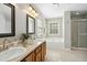 Bright bathroom featuring double sinks, garden tub, and glass-enclosed shower at 109 Faldo Cv, Raleigh, NC 27603