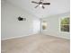 Spacious bedroom with neutral carpeting, ample natural light, and ceiling fan at 109 Faldo Cv, Raleigh, NC 27603