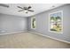 Spacious bedroom with carpet, ceiling fan, and two windows at 109 Faldo Cv, Raleigh, NC 27603