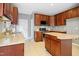 Well-equipped kitchen featuring wooden cabinets, granite countertops, an island, and stainless steel appliances at 109 Faldo Cv, Raleigh, NC 27603