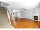 Spacious living room with hardwood floors, fireplace, staircase, and an open, airy design at 109 Faldo Cv, Raleigh, NC 27603