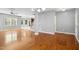 Open-concept living space with gleaming hardwood floors, neutral walls and staircase at 109 Faldo Cv, Raleigh, NC 27603