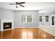 Inviting living room boasts a fireplace, ceiling fan, hardwood floors, and natural light at 109 Faldo Cv, Raleigh, NC 27603