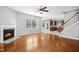 Open floor plan showcasing hardwood floors, a fireplace, staircase, and seamless flow to the kitchen at 109 Faldo Cv, Raleigh, NC 27603